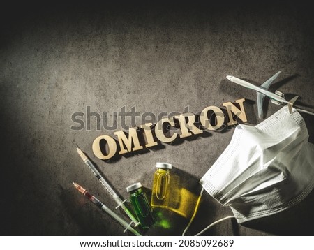 Omicron word and airplane model and medical supplies