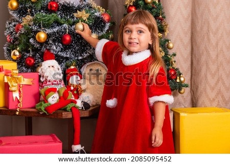 Caucasian kid arrange decorate christmas tree with fun and cheerful christmas festive ideas concept