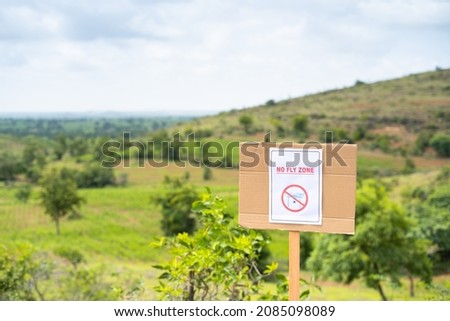 Focus on Sign board, No fly zone Sign board on top of Hill - concept of drone restrictive zones