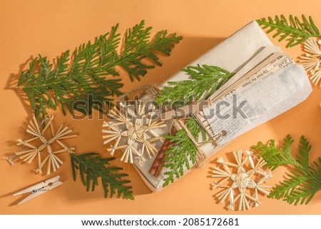 Zero waste gift concept. Christmas or New Year eco-friendly packaging. Festive boxes in craft paper with different organic decorations. Trendy hard light, dark shadow, top view, flat lay
