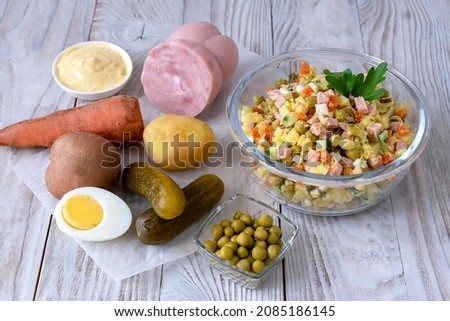 Olivier salad and ingredients for cooking. Traditional Russian dish for the new year. Royalty-Free Stock Photo #2085186145