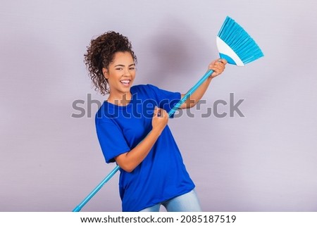 Housewife woman. Cleaner. Young man holding broom on white background with free space for text.