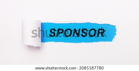 On a bright blue background, white paper with a torn stripe and the text SPONSOR Royalty-Free Stock Photo #2085187780