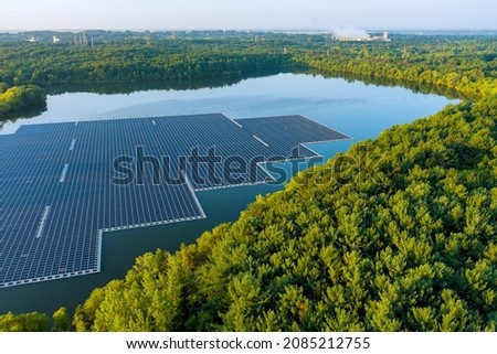 Aerial top view of environmentally friendly energy with floating solar panels platform system on the lake Royalty-Free Stock Photo #2085212755