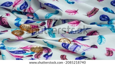 Cotton, jersey fabric. bird feather print on white background. A jersey made from cotton is usually a thin single knit fabric with an obvious right side and back,