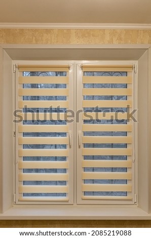 window half closed with striped blinds day-night. High quality photo