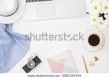 Flat lay blogger or freelancer workspace with a notebook, laptop a cup of coffee on a white background