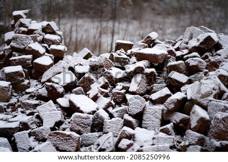 The texture of large stones with snow. Background of cobblestones. High quality photo Royalty-Free Stock Photo #2085250996