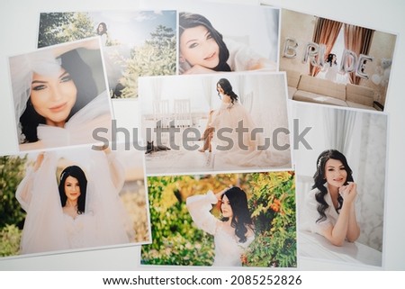 printed on paper photos of a beautiful brunette bride. photo printing in printing or photo laboratory. the result of the photographer's work after the wedding photo shoot.