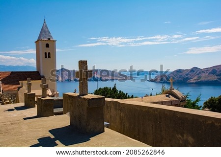 St John the Baptist Church and cemetrey, on a hill overlooking Baska town on Krk island, Primorje-Gorski Kotar County. Also called Crkva Svetog Ivana. The island in the background is Otok Prvic