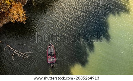 Bass fisherman fishing out of bass boat on fall afternoon. Drone photo taken from above at grand lake oklahoma Royalty-Free Stock Photo #2085264913