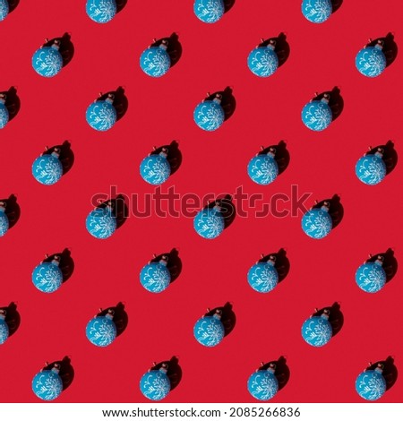 Seamless texture Christmas, blue ball on a red background. Pattern.