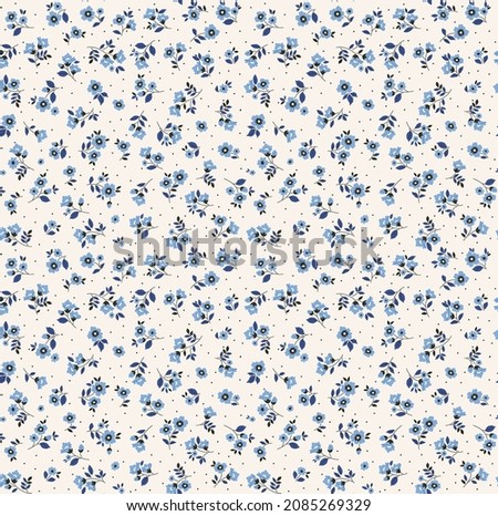 Vintage floral background. Floral pattern with small blue flowers on a ivory white background. Seamless pattern for design and fashion prints. Ditsy style. Stock vector illustration. Royalty-Free Stock Photo #2085269329