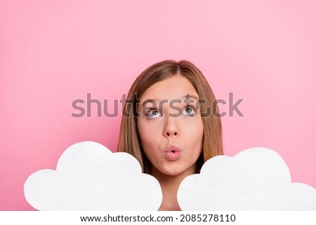 Photo of impressed little brown hairdo girl hold clouds look up isolated on pink color background