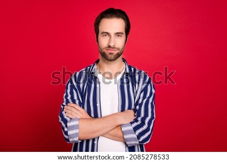 Photo of young man good mood confident crossed hands wear casual clothes isolated over red color background
