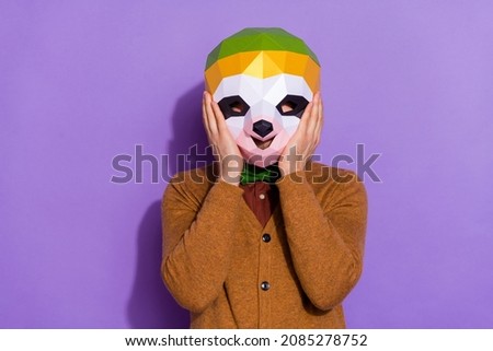 Photo of young man arms touch unusual face mask halloween event red panda isolated over violet color background