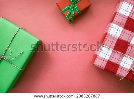Christmas background with gift boxes and red decorations. Preparation for the holiday. Top view with copy space.