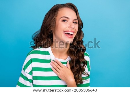 Photo of funny brunette wavy millennial lady laugh wear striped t-shirt isolated on blue color background