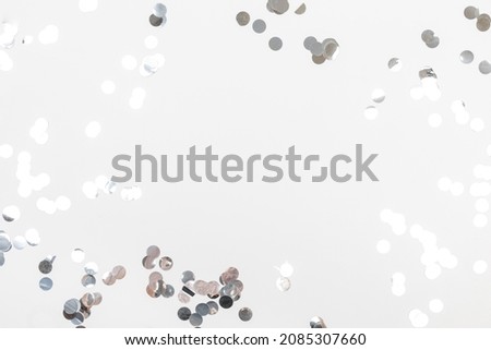 round silver confetti on white background flat lay text place - Image 