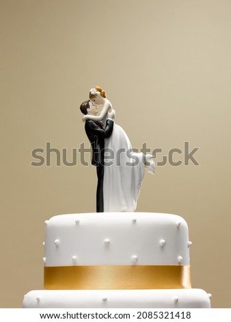 Bride and groom topper on wedding cake Royalty-Free Stock Photo #2085321418