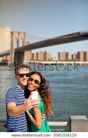 Couple taking picture together by city cityscape