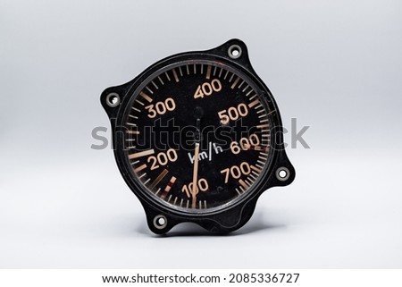 Vintage airspeed indicator isolated on a white background, making a great aviation wallpaper. This speedometer is from a dashboard of a fast plane. Royalty-Free Stock Photo #2085336727