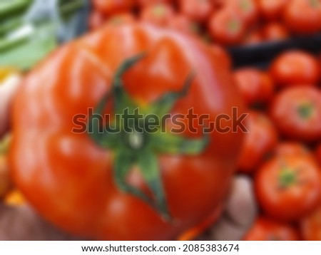 Defocused Abstract Background of fresh Red Tomato Organic Vegetable Products. Stock Photo on blurred tomato background. Fruits concept.