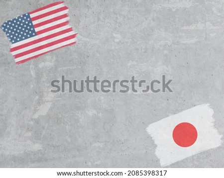 Concrete wall painted with USA and Japan flags with a dry brush
