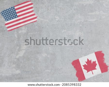 Concrete wall painted with USA and Canada flags with a dry brush