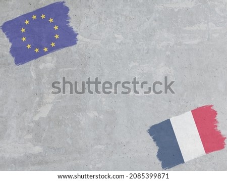 Concrete wall painted with EU and France flags with a dry brush