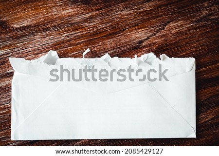 Selective focus on jagged edges of a ripped open mail envelope  Royalty-Free Stock Photo #2085429127