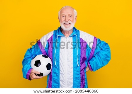 Photo of senior man gamer player goal champion trainee intense regime isolated over yellow color background