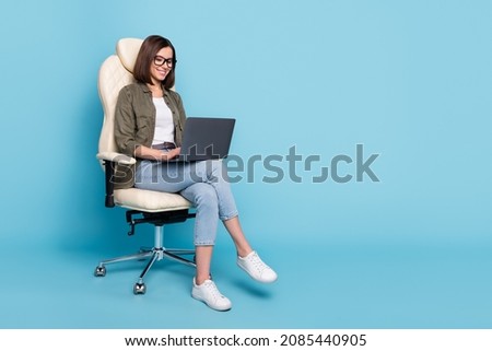 Full body photo of manager ceo lady sit chair use device netbook online communicate wear jeans isolated over blue color background Royalty-Free Stock Photo #2085440905