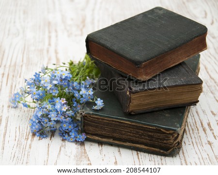 Bunch of forget-me-nots flowers and very old books