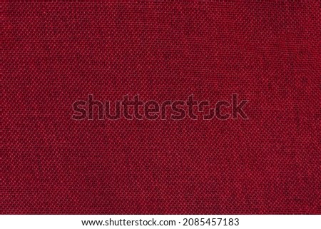 Red burlap background. Rough tissue structure. Texture