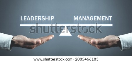 Male hands holding Leadership and Management balance scale. Royalty-Free Stock Photo #2085466183