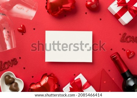 Top view photo of valentine's day decorations paper card gift boxes heart shaped balloons candies hearts two wineglasses shiny confetti envelope wine bottle on isolated red background with copyspace