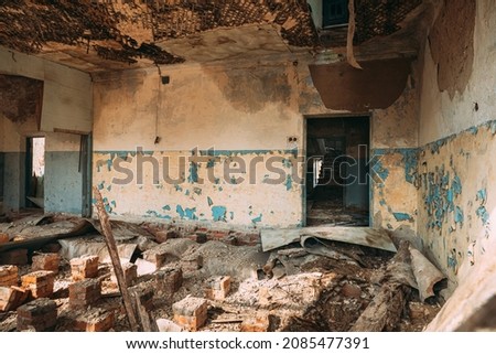 Abandoned Ruined Old Village School Building In Chernobyl Resettlement Zone. Belarus. Chornobyl Catastrophe Disasters. Dilapidated House In Belarusian Village. Whole Villages Must Be Disposed Royalty-Free Stock Photo #2085477391