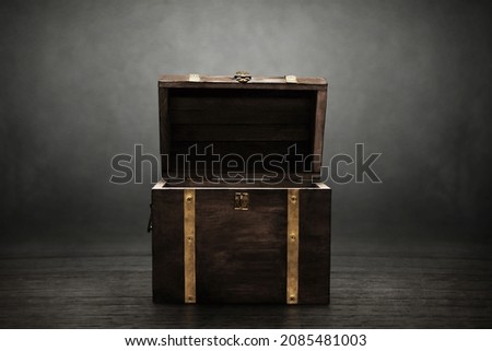 Wooden treasure chest on dark background Royalty-Free Stock Photo #2085481003