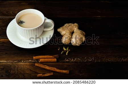 Masala chai with spices cinnamon , cardamom, ginger, clove and star anise on wooden background. High quality photo