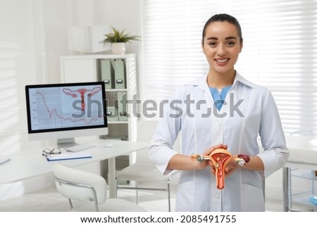 Gynecologist demonstrating model of female reproductive system in clinic Royalty-Free Stock Photo #2085491755
