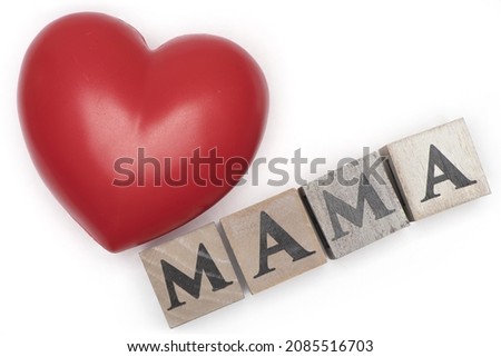 a big red heart next to wooden letter cube showing mama isolated on white background as a concept for mother love and mother's day
