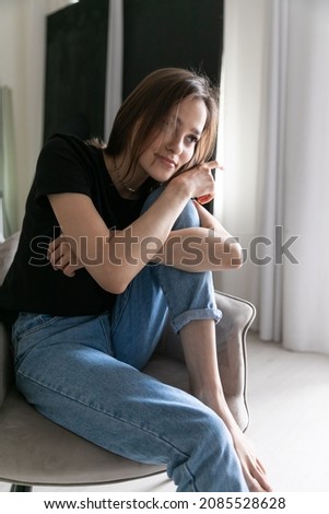 portrait of a beautiful fashionable young woman in jeans and t-shirt