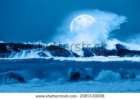 Rocky coastline with strong sea  wave and Night sky in the full moon "Elements of this image furnished by NASA