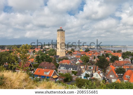 Old lighthouse in a small village on the island Terschelling in the Netherlands Royalty-Free Stock Photo #208555681