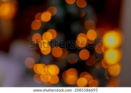 Blurred picture of coloured bokeh, Out of focus photo of light leaks in the dark, Yellow orange circle spotted light texture, Abstract pattern background.