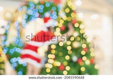 Blur Santa woman, woman in Santa Claus costume and Christmas tree in Merry Christmas xmas indoors