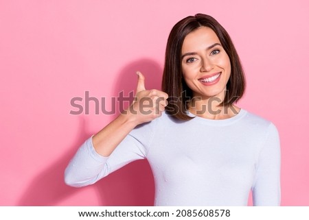Photo of pretty shiny young woman wear white sweater recommending you good shopping mall isolated pink color background