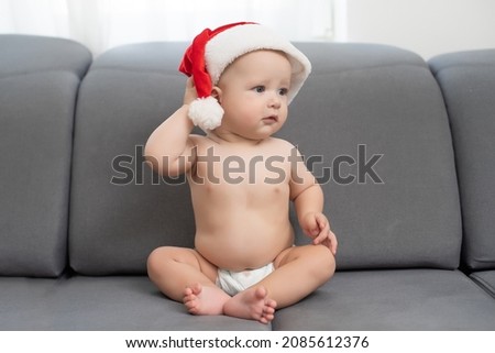 Christmas little baby boy, baby in santa hat.