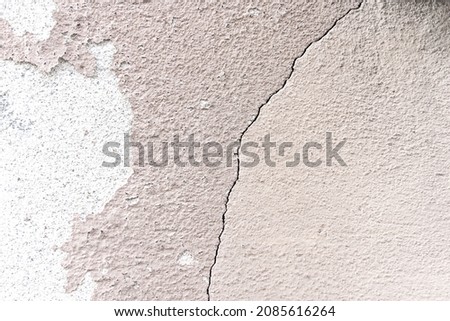 concrete wall texture detail - Natural stucco surface background with a crack 
